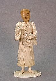 JAPANESE BONE AND TAGUA CARVING OF A MERCHANT