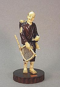 JAPANESE WOOD & WALRUS CARVING OF A FISHERMAN