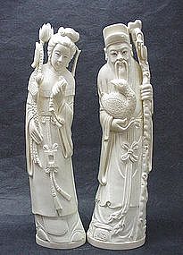 A PAIR OF CHINESE CARVED IVORY STATUES