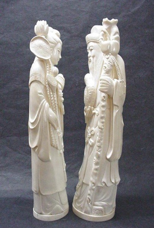 A PAIR OF CHINESE CARVED IVORY STATUES