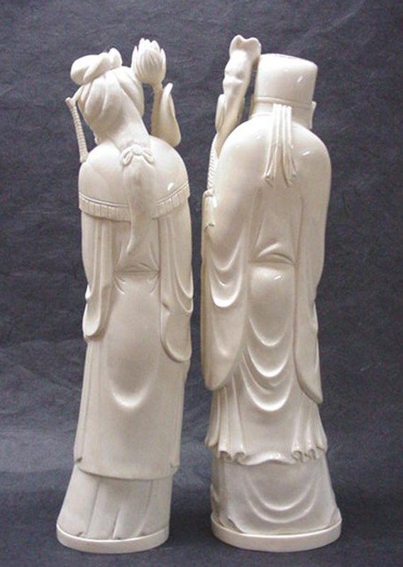 A PAIR OF CHINESE CARVED IVORY STATUES