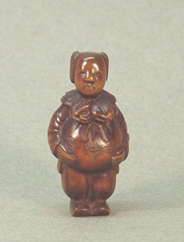 JAPANESE CARVED WOOD NETSUKE OF A YOUNG BOY