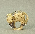 JAPANESE CARVED IVORY NETSUKE OF A MYTHICAL BEAST