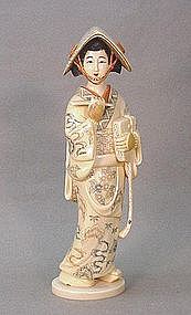 JAPANESE 20TH CENTURY CARVED IVORY OKIMONO OF A GEISHA