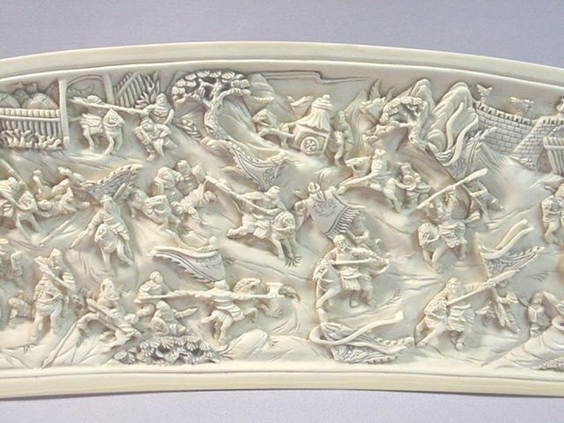 CHINESE CARVED IVORY PANEL OF A BATTLE SCENE