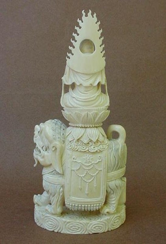 CHINESE CARVED IVORY BUDDHA WITH LION
