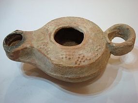 A TERRACOTTA OIL LAMP FROM THE HOLY LAND