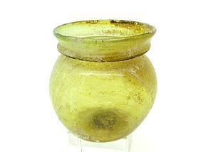 A ROMAN GREEN GLASS JAR