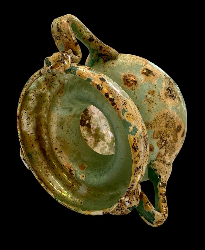 A ROMAN TWO HANDLED GLASS JAR