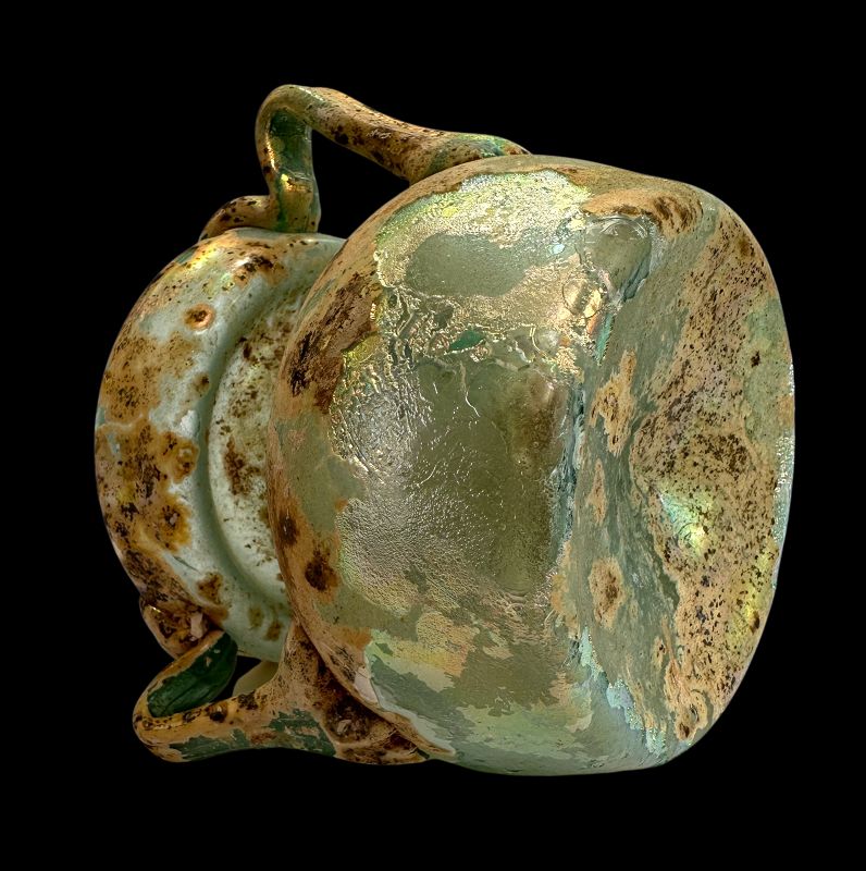 A ROMAN TWO HANDLED GLASS JAR