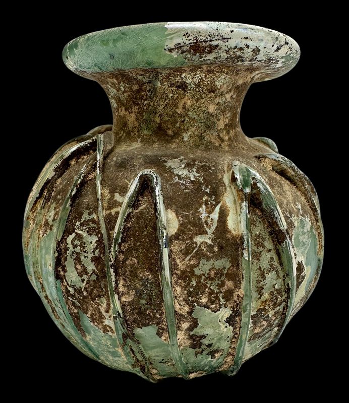 A ROMAN GLASS JAR WITH APPLIED TRAILING