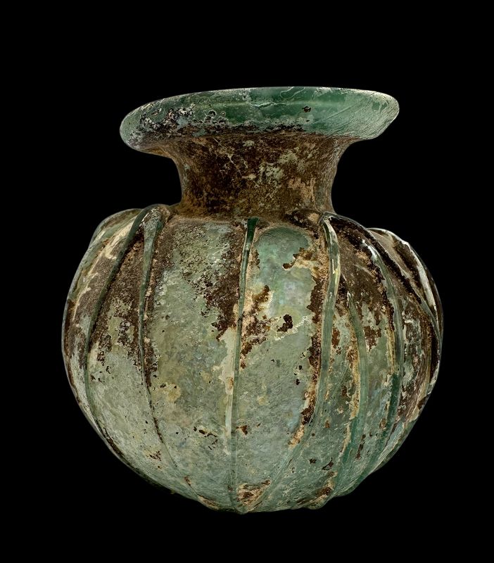 A ROMAN GLASS JAR WITH APPLIED TRAILING