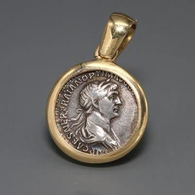 A SILVER DENARIUS OF TRAJAN IN A 18K GOLD PENDANT