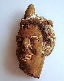 A HELLENISTIC TERRACOTTA HEAD OF A WOMAN OR A GODDESS