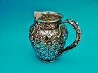 Peter Krider repoussé chased sterling bar pitcher,