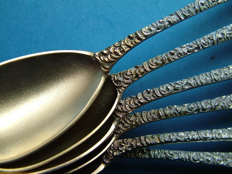 12 Antique, chased egg spoons with gilt matte finish