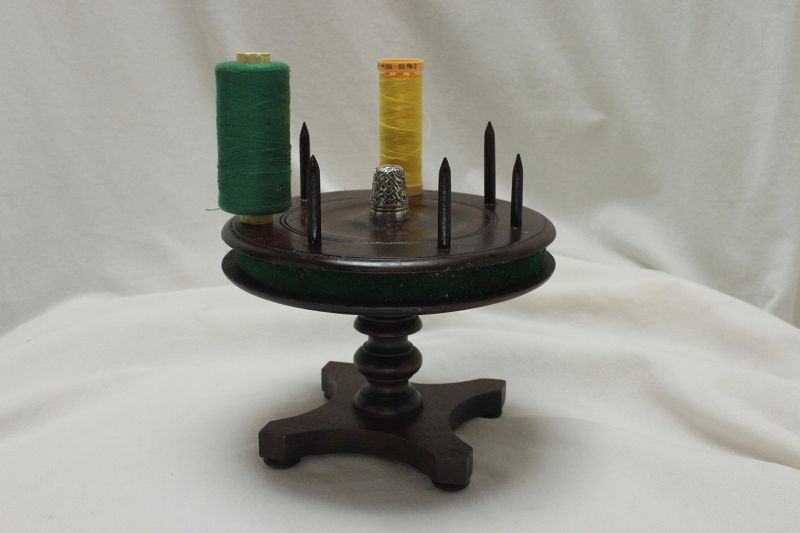 Revolving cotton reel holder in the shape of a table
