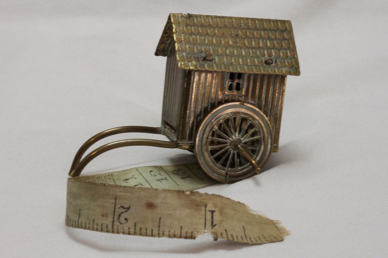 Brass novelty tape measure in the form of a Victorian bathing box