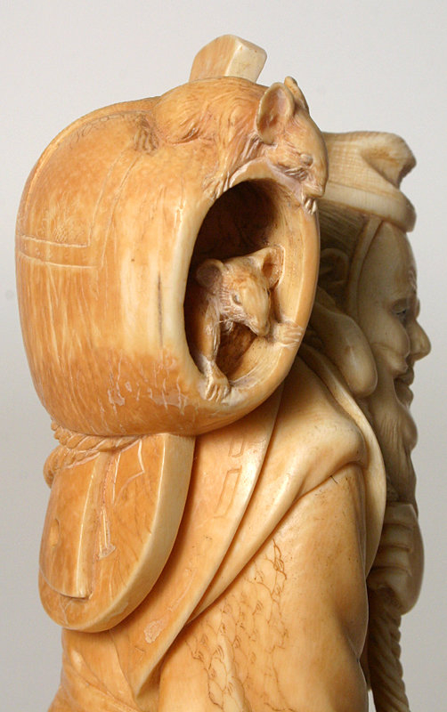 Japanese carved ivory okimono of a peddler with fish