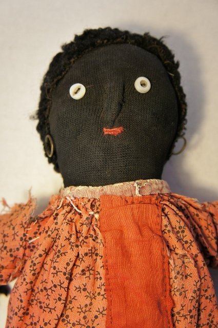 Old black cloth doll with red calico dress antique stockinette