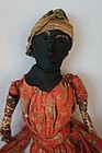 A black cloth doll in original clothes sweet face 1880