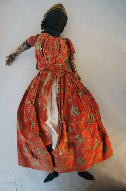 A black cloth doll in original clothes sweet face 1880