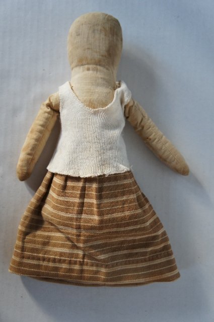 Early cloth doll with pencil face antique brown ticking skirt