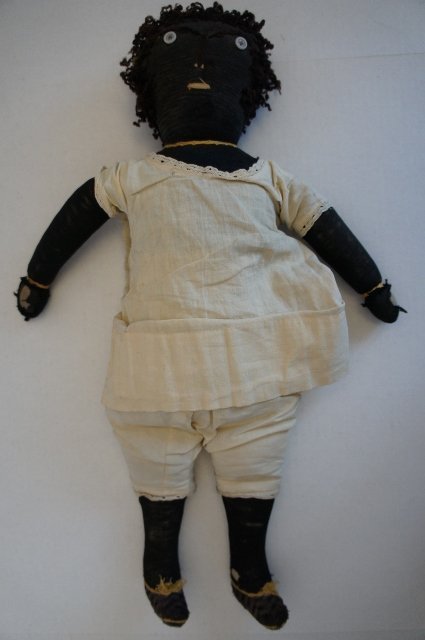 Antique black cloth rag doll with embroidered face