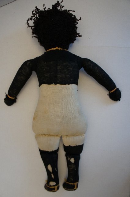 Antique black cloth rag doll with embroidered face