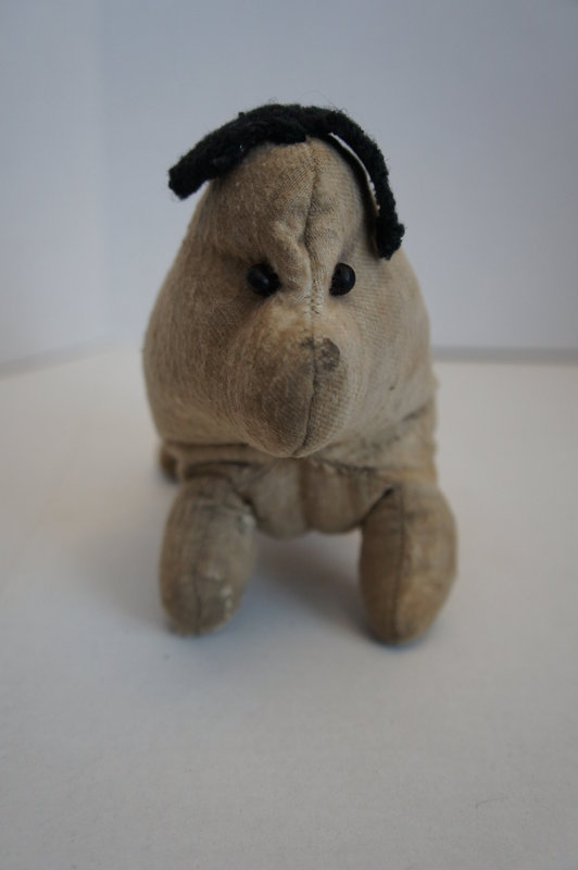 Antique Amish type flannel dog with worried look 19th C.