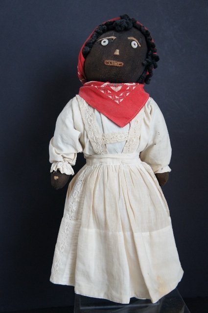 Black cloth bottle doll with great embroidered face and clothes