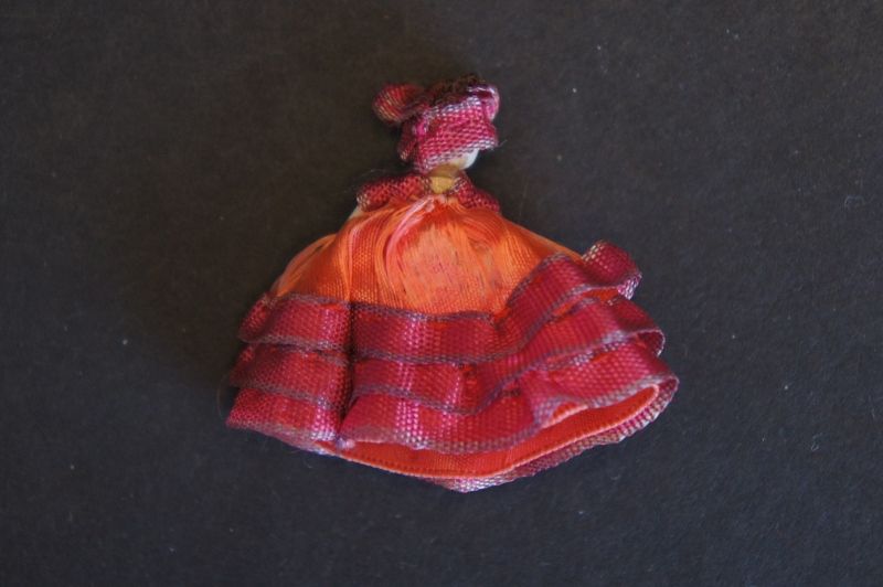 Miniature wooden penny doll in round Dresden wallpapered box