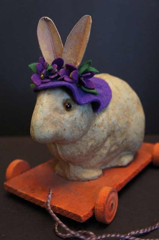 Pull toy rabbit in a purple hat