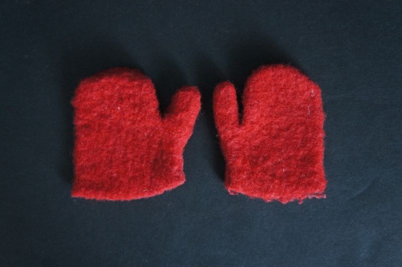 Very small child's first mittens, red wool hand sewn