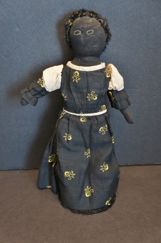 A darling  10&quot; stockinette doll with calico dress and astrakhan hair