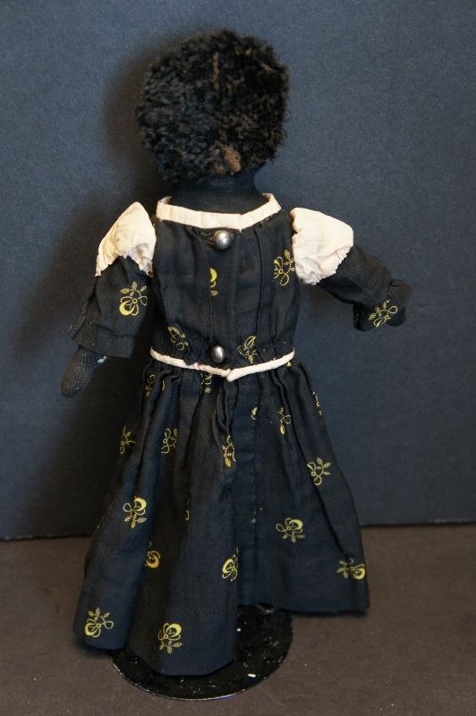 A darling  10&quot; stockinette doll with calico dress and astrakhan hair