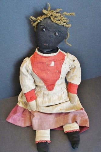 21"  black doll with shoe button eyes and yarn hair.