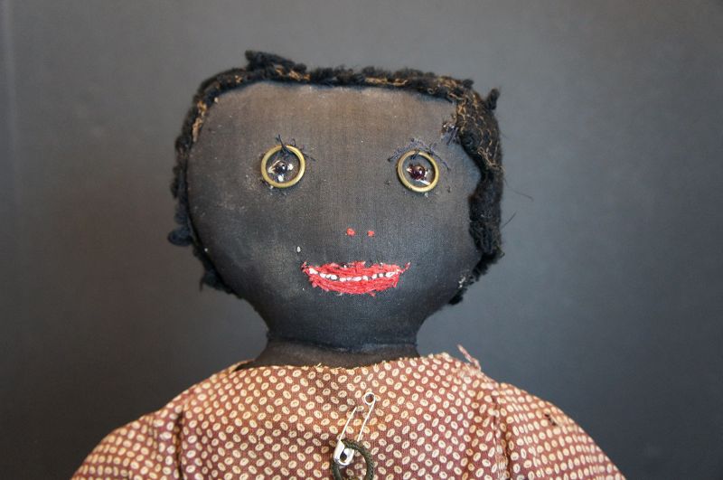 Very folky black doll with curtain ring eyes and a squared off head