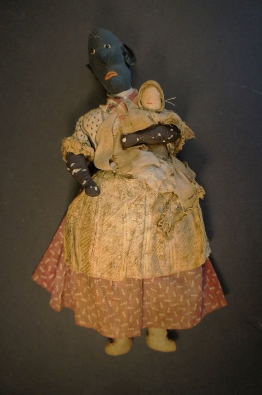 An endearing black doll holding a white baby 12&quot; C. 1890