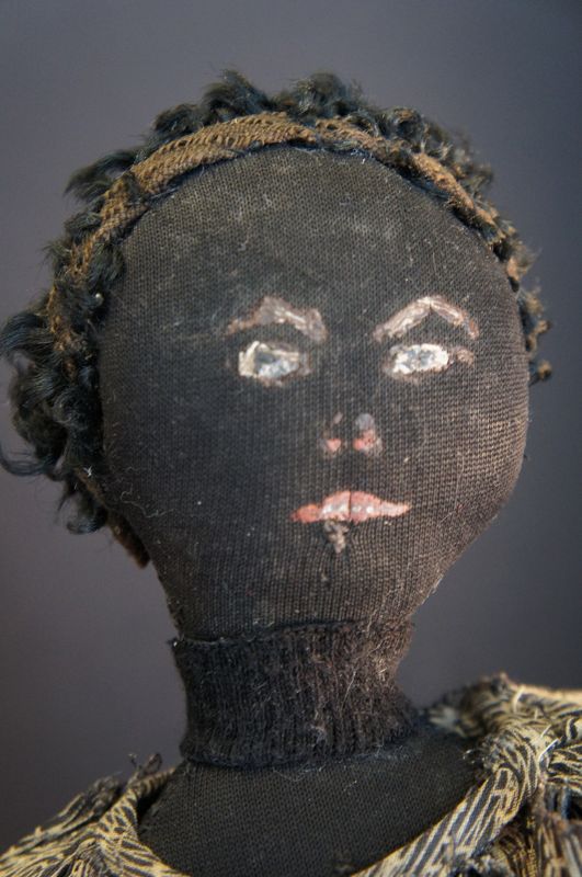 an unpretentious  black cloth doll with a great painted face 17&quot; 1880