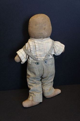 A little fellow, plump and sturdy with his favorite overalls 14"