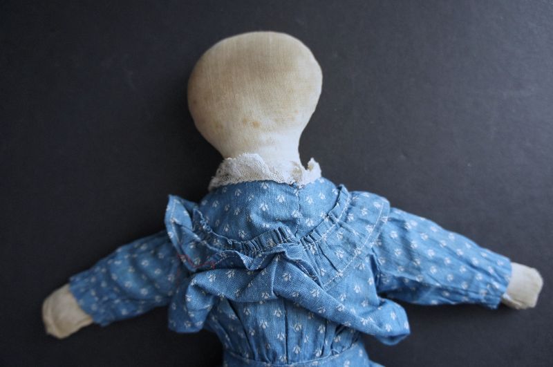 Old played with antique cloth doll wearing a blue calico dress 1880-90