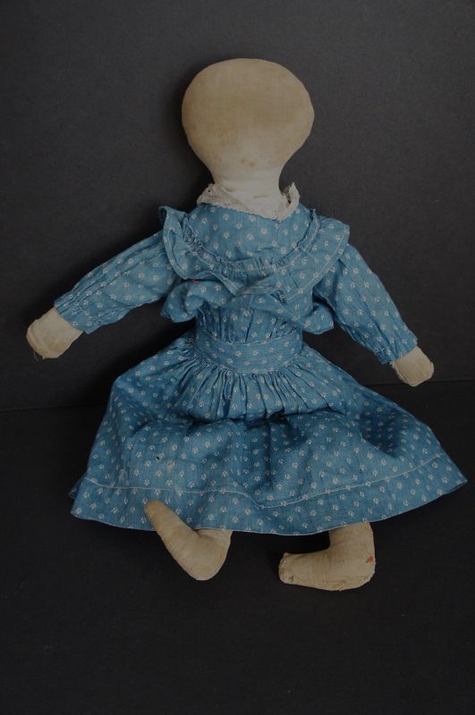 Old played with antique cloth doll wearing a blue calico dress 1880-90