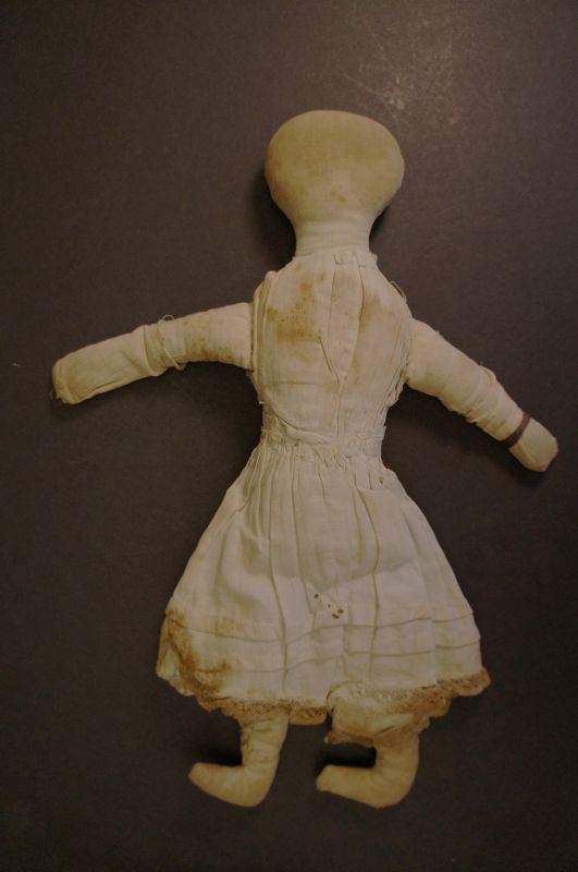 Old played with antique cloth doll wearing a blue calico dress 1880-90