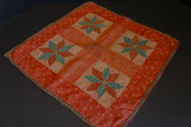 Antique red calico doll quilt woth a brown calico borders. 1890