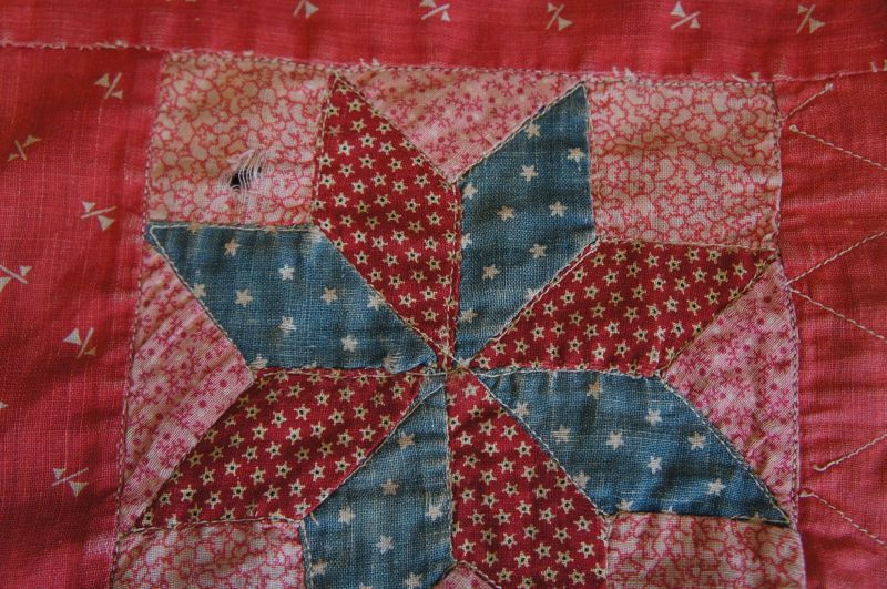 Antique red calico doll quilt woth a brown calico borders. 1890
