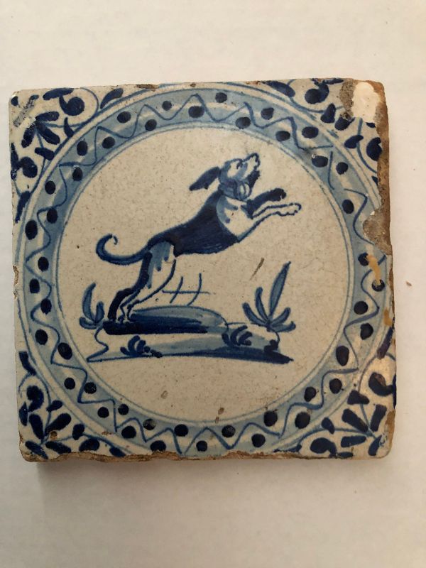A Dutch Delft tile of a leaping dog circa 1650