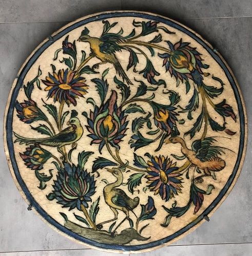 Large Qajar circular tile of birds and flowers, 19th century