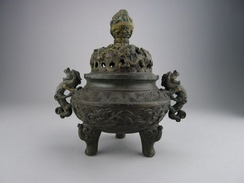 A richly decorated and marked Qing Dynasty Bronze Tripod Censer