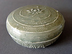 A rare Yue Ware covered box with a molded decoration